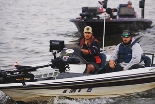 Anglers running a bass boat on tournament day